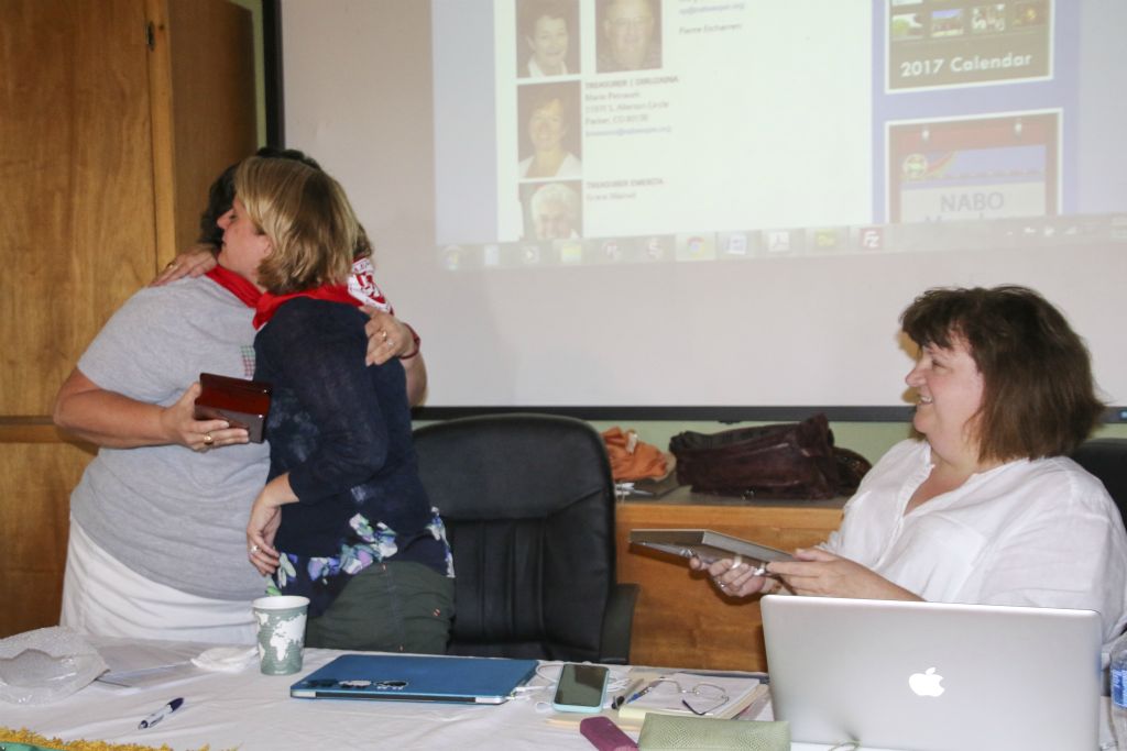 Kate Camino presents gifts to outgoing president and secretary